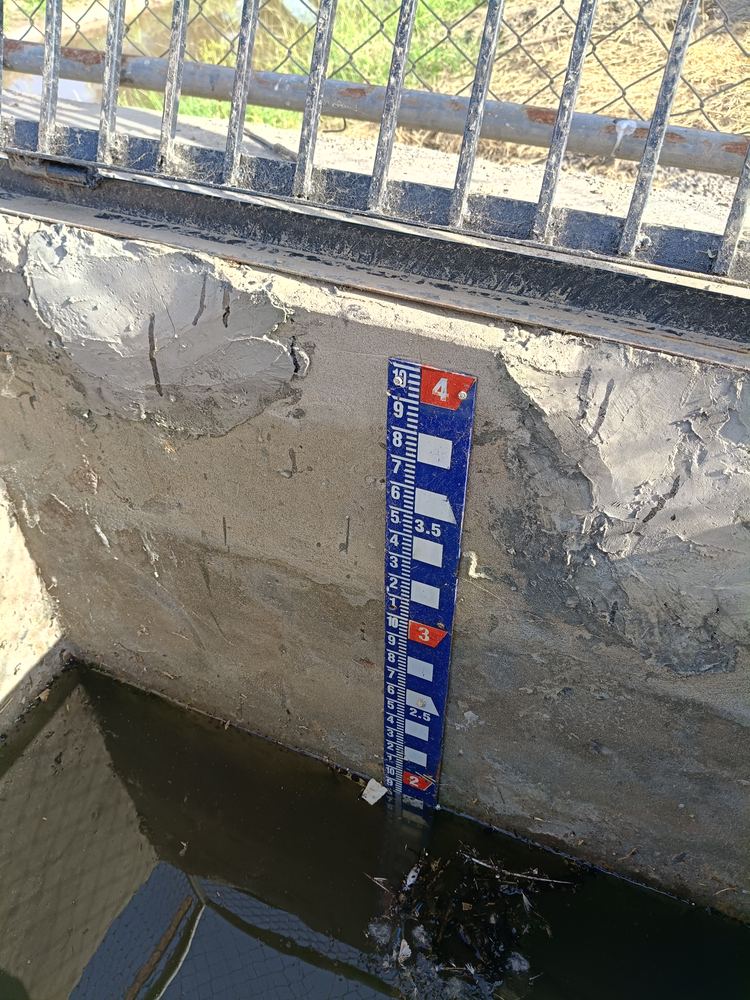 Company Overview Staff gauge board on a canal gauge well showing water level in feet