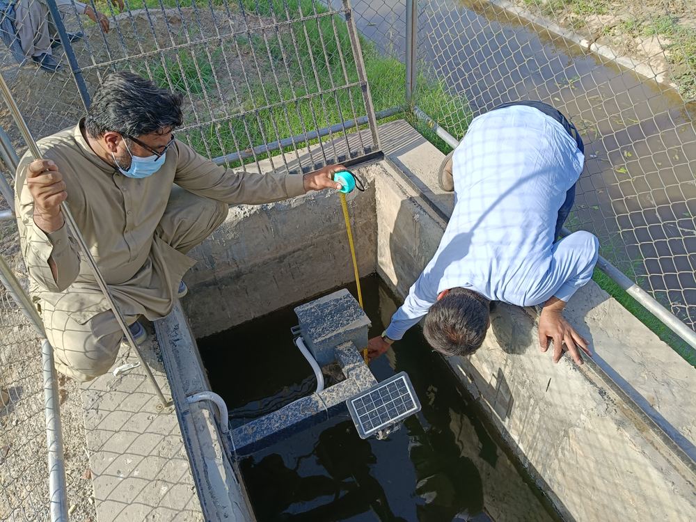 Company Overview Manual tape measurement taken against an installed water level sensor for calibration
